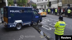 A police van carrying Michael Adebowale leaves Westminster Magistrates Court in London, May 30, 2013. 