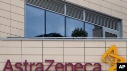 FILE - In this Saturday, July 18, 2020 file photo a general view of AstraZeneca offices and the corporate logo in Cambridge, England. AstraZeneca says late-stage trials of its COVID-19 vaccine were "highly effective'' in preventing disease. A…