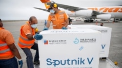 Workers take care of a shipment of Russia's Sputnik V vaccine at the airport in Caracas, Venezuela, on March 29, 2021.