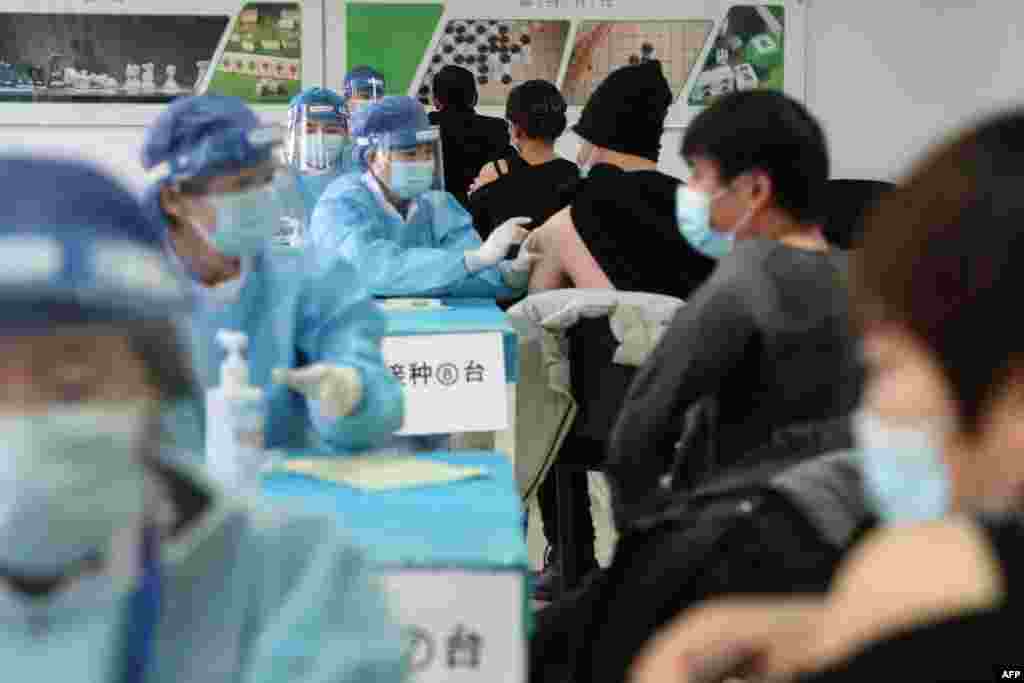 People receive COVID-19 vaccines at a temporary vaccination center in Beijing.