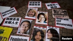 FILE - Portraits of Li Tingting (top L), Wei Tingting (top R), (bottom, L-R) Wang Man, Wu Rongrong and Zheng Churan are pictured during a protest calling for their release in Hong Kong, April 11, 2015.