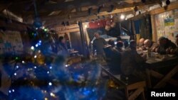 Ukrainian service members have a lunch at a position near the border with Belarus, amid Russia's attack on Ukraine, in Zhytomyr region, Ukraine Dec. 27, 2022.