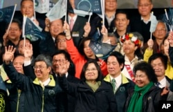 FILE - Taiwan's Democratic Progressive Party, DPP, presidential candidate, Tsai Ing-wen, waves as she declares victory in the presidential election in Taipei, Taiwan, Jan. 16, 2016.
