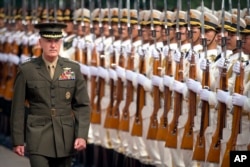 Joint Chiefs Chairman Gen. Joseph Dunford reviews a Chinese honor guard during a welcome ceremony at the Bayi Building in Beijing, Aug. 15, 2017.