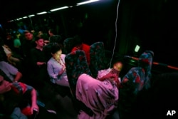 Student survivors from Marjory Stoneman Douglas High School, where 17 students and faculty were killed in a shooting last Wednesday, ride during the night aboard their bus between Parkland, Fla., and Tallahassee, Fla., Feb. 20, 2018.