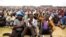 FILE - Miners gather at Wonderkop stadium outside the Lonmin mine in Rustenburg, northwest of Johannesburg, Jan. 30, 2014. 
