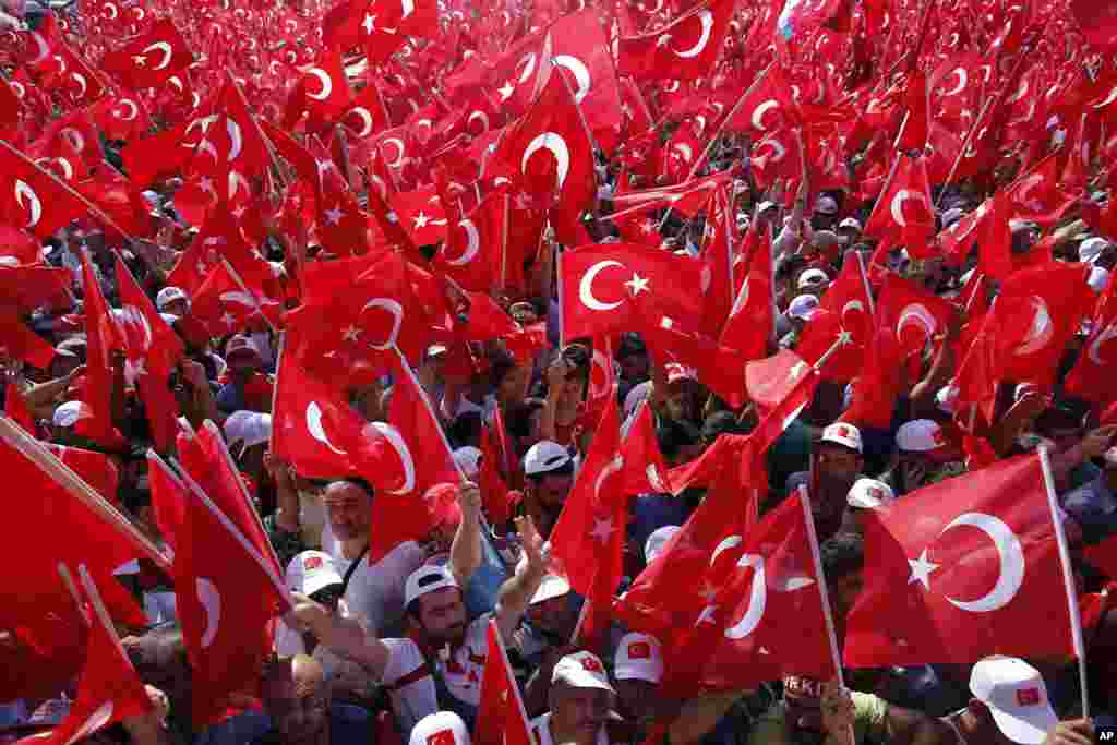 Massive crowds wave Turkish flags as they take part in a Democracy and Martyrs' Rally in Istanbul, Aug. 7, 2016. 