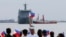 FILE - Relatives of crew of BRP Tarlac of the Philippine Navy wave Philippine flags to welcome its arrival at the South Harbor in Manila, Philippines, May 16, 2016. The radars Manila is purchasing from the U.S. will be mounted on Navy ships.