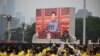 Presiden China Xi Jinping (di layar) menyampaikan pidato pada perayaan 100 tahun berdirinya Partai Komunis China di Lapangan Tiananmen, Beijing, 1 Juli 2021. (Foto: WANG Zhao / AFP)