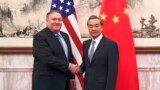 U.S. Secretary of State Mike Pompeo, left, shakes hands with Chinese Foreign Minister Wang Yi before their meeting at the Diaoyutai State Guesthouse in Beijing, Oct. 8, 2018.