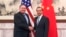 U.S. Secretary of State Mike Pompeo, left, shakes hands with Chinese Foreign Minister Wang Yi before their meeting at the Diaoyutai State Guesthouse in Beijing, Oct. 8, 2018.