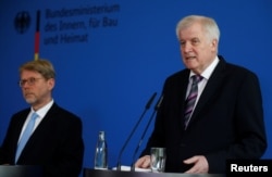 German Interior Minister Horst Seehofer (R) introduces Hans-Eckhard Sommer as new head of the Federal Office for Migration and Refugees (BAMF), in Berlin, Germany, June 20, 2018.