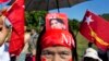 A supporter displays a picture of opposition leader Aung San Suu Kyi stuck in her headband during a campaign rally of the National League for Democracy in Thandwe, Myanmar, Oct. 17, 2015. 