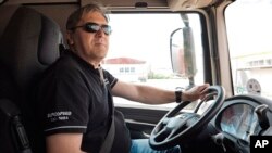 FILE - Bulgarian truck driver Ivan Gospodinov sits in a Eurospeed truck cab at a parking lot in Sofia, Bulgaria, May 8, 2019. 