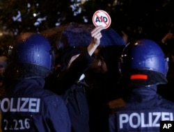 Police block demonstrators protesting the nationalist Alternative for Germany, AfD, party in Berlin, Germany, Sept. 24, 2017.