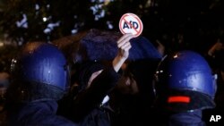 Polisi menghalangai para pengunjuk rasa menentang partai nasionalis Alternative for Germany (AfD) di Berlin, Jerman, 24 September 2017, setelah TPS-TPS untuk pemilihan parlemen Jeman ditutup (foto: AP Photo/Michael Probst).