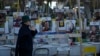 A woman looks at a display of empty chairs representing hostages held by the Hamas militant group in the Gaza Strip in Tel Aviv, Israel, Jan. 24, 2025. 