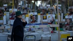 A woman looks at a display of empty chairs representing hostages held by the Hamas militant group in the Gaza Strip in Tel Aviv, Israel, Jan. 24, 2025. 