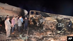 FILE: In an earlier accident, the authorities work on the collision site where a bus overturned while trying to pass a truck on a highway in southern Egypt on Wednesday, April 14, 2021, near the city of Assiut.