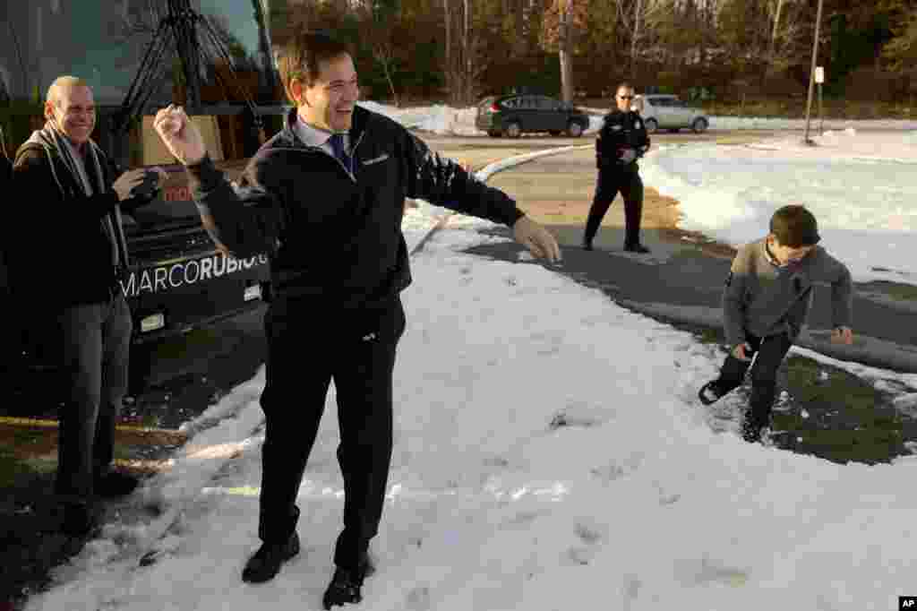 Republican presidential candidate, Senator Marco Rubio, holds a snow ball while playing with his children after a campaign stop Feb. 7, 2016, in Hudson, New Hampshire.