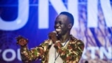 FILE - Comedian Kuech Deng Atem performs during the "Comedy for Peace" event, supported by the United Nations Mission in South Sudan (UNMISS), held at the Nyakuron Cultural Centre, April 23, 2017, in Juba. (Photo courtesy UNMISS)