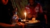 FILE - Middlemen and jade miners gather at a house to smoke opium, heroine and yaba in a village near a jade mine in Hpakant township, Kachin State, Myanmar, July 7, 2013.