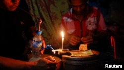 FILE - Middlemen and jade miners gather at a house to smoke opium, heroine and yaba in a village near a jade mine in Hpakant township, Kachin State, Myanmar, July 7, 2013.