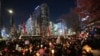 People hold candles during a candlelight vigil against South Korean President Yoon Suk Yeol in Seoul, South Korea, Dec. 4, 2024. 