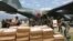 Indonesian and Japanese military personnel unload relief aid from a Japan Air Force cargo plane at the Mutiara Sis Al-Jufri airport in Palu, Central Sulawesi, Indonesia, Oct. 6, 2018.
