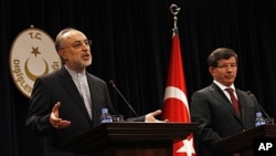 Turkey's Foreign Minister Ahmet Davutoglu, right, and Iranian counterpart Ali Akbar Salehi, Ankara, Oct. 21, 2011.