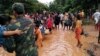 Villagers carry their belongings as they evacuate after the Xepian-Xe Nam Noy hydropower dam collapsed in Attapeu province, Laos, July 24, 2018.