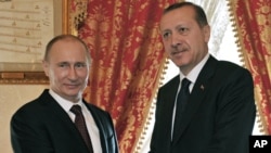 Turkish Prime Minister Recep Tayyip Erdogan, right, and Russian President Vladimir Putin shake hands at their meeting in Istanbul, Turkey, Monday, Dec. 3, 2012. 