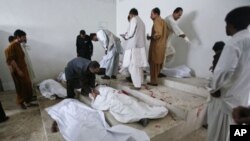 Family members and hospital staff try to identify the victims of a double suicide bombing at a morgue in Quetta September 7, 2011.