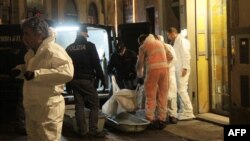 Police officers and forensics experts carry the body of Ashley Olsen, a 35-year-old American expatriate artist who was found dead in her apartment, in Florence, Italy, Jan. 9, 2016. 