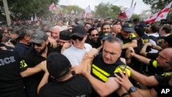 FILE - Police block Georgian opponents of gay rights as they try to interfere with a pride event in Tbilisi on July 8, 2023. Georgia's parliament on June 27, 2024, advanced several anti-LGBTQ+ bills.