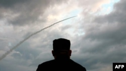 FILE - North Korean leader Kim Jong Un watches the launch of a ballistic missile at an unknown location in North Korea on July 31, 2019, in this screen grab image taken from North Korean broadcaster KCTV. 