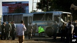 Petugas keamanan Afghanistan berjalan di sekitar bus tentara menyusul serangan bunuh diri di Kabul, Afghanistan (1/10).