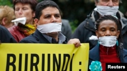 Amnesty International activists demonstrate against a new law limiting press freedom in Burundi during a protest in front of the Burundi embassy in Brussels, May 31, 2013. 