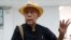 Thai social critic Sulak Sivaraksa talks to reporters at a police station before going to Bangkok military court in Bangkok, Thailand, Oct. 9, 2017. Sulak faces up to 15 years in prison for offending the monarchy.
