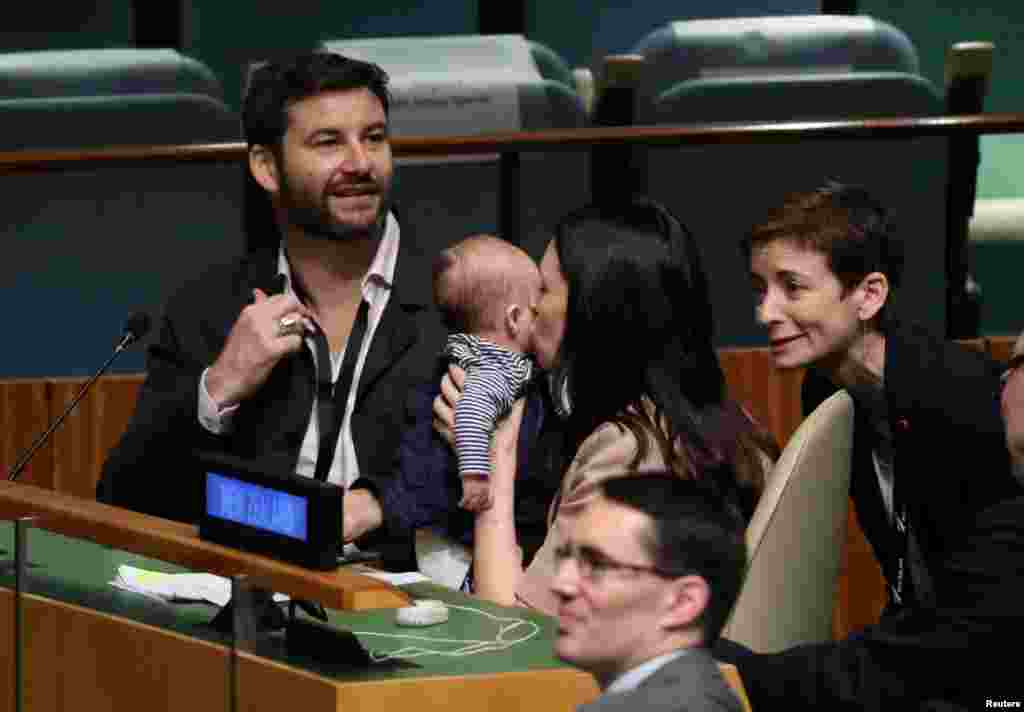 New Zealand Prime Minister Jacinda Ardern kisses her baby Neve before speaking at the Nelson Mandela Peace Summit during the 73rd United Nations General Assembly in New York, Sept. 24, 2018.