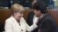 German Chancellor Angela Merkel greets Bolivian President Evo Morales at a European Union-Community of Latin American and Caribbean States summit in Brussels, June 10, 2015.