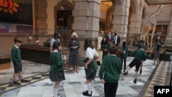 FILE - Britain's Camilla, Duchess of Cornwall talks to school children during a visit to Kelvingrove Art Gallery and Museum in Glasgow, Scotland, on Sept. 8, 2021, as the institution celebrates its 120th anniversary. 