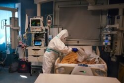 Medical staff tends to a patient in the ICU unit of San Filippo Neri Hospital's Covid department, in Rome, Italy, April 9, 2020.