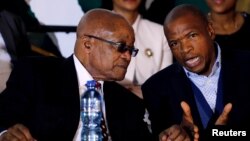 FILE - South Africa's President Jacob Zuma, left, chats with Premier of North West Province Supra Mahumapelo in Ventersdorp, South Africa, June 16, 2017. 