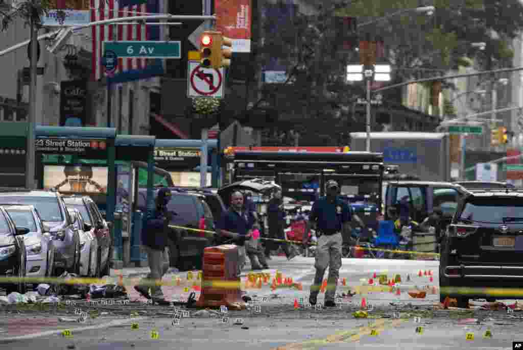 Crime scene investigators work at the scene of Saturday's explosion in Manhattan's Chelsea neighborhood, in New York, Sept. 18, 2016.