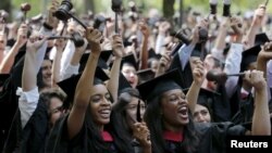 Students graduating from the School of Law cheer as they receive their degrees during the 364th Commencement Exercises at Harvard University in Cambridge, Massachusetts May 28, 2015. REUTERS/Brian Snyder - RTX1EZC9