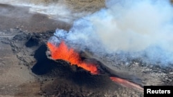 FILE - Lava spurts and flows after the eruption of a volcano in the Reykjanes Peninsula in Iceland on July 12, 2023. Officials reported on Oct. 27 that the same area felt thousands of small earthquakes this week. (Civil Protection of Iceland via Reuters)