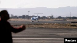 FILE - A plane carrying members of a United Nations team arrives at Sanaa airport, Yemen, Dec. 22, 2018. The Saudi-led coalition attack a nearby air base, May 1, 2019.