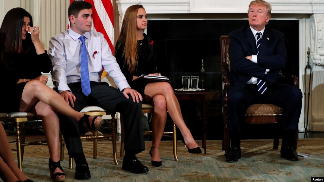Parent Melissa Blank, from left, and Marjory Stoneman Douglas High School shooting surviving students Jonathan Blank and Julia Cordover attend with other survivors and the families of victims a listening session held by U.S. President Donald Trump to discuss school safety and shootings, at the White House in Washington, Feb. 21, 2018. 
