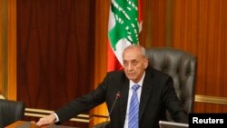 FILE - Lebanese Parliament speaker Nabih Berri strikes his gavel at the end of a parliamentary session in parliament in Beirut, May 31, 2013.